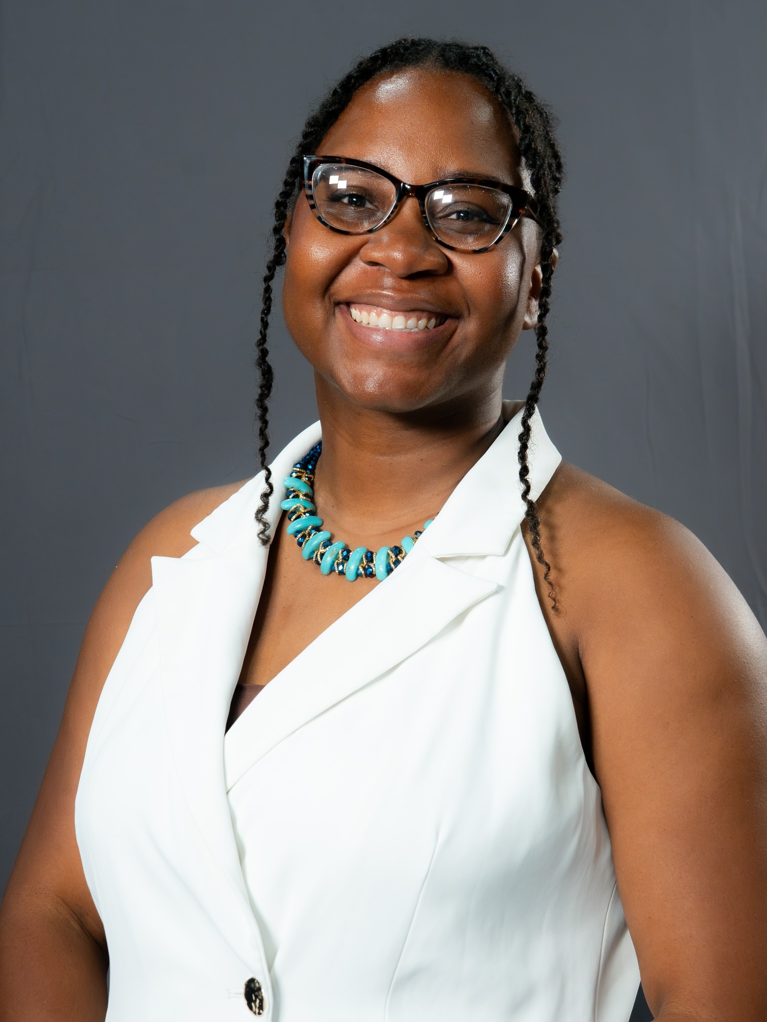 Dr. Atasha Jordan smiling in a white blazer