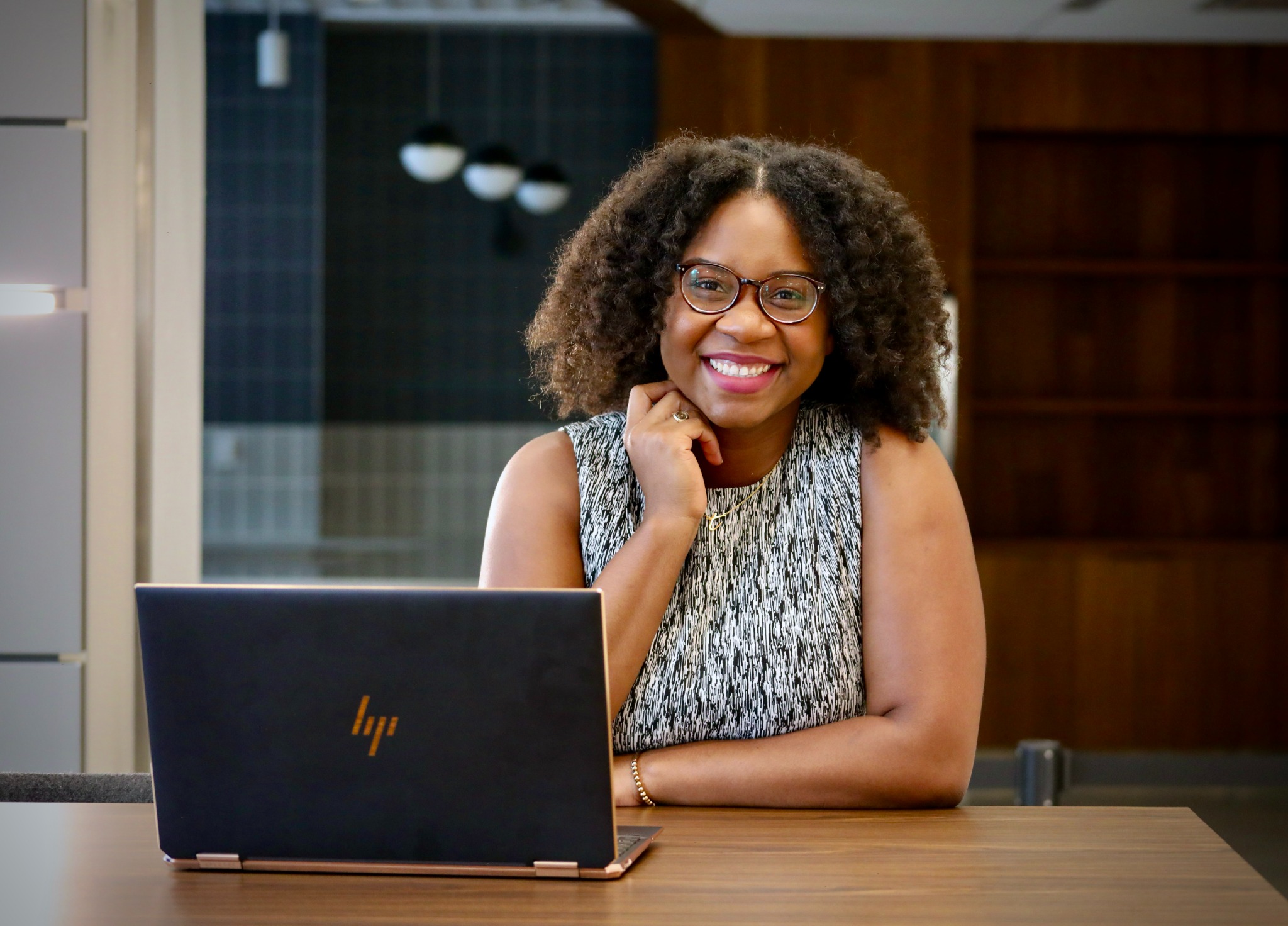 Dr. Atasha Jordan seated with a laptop