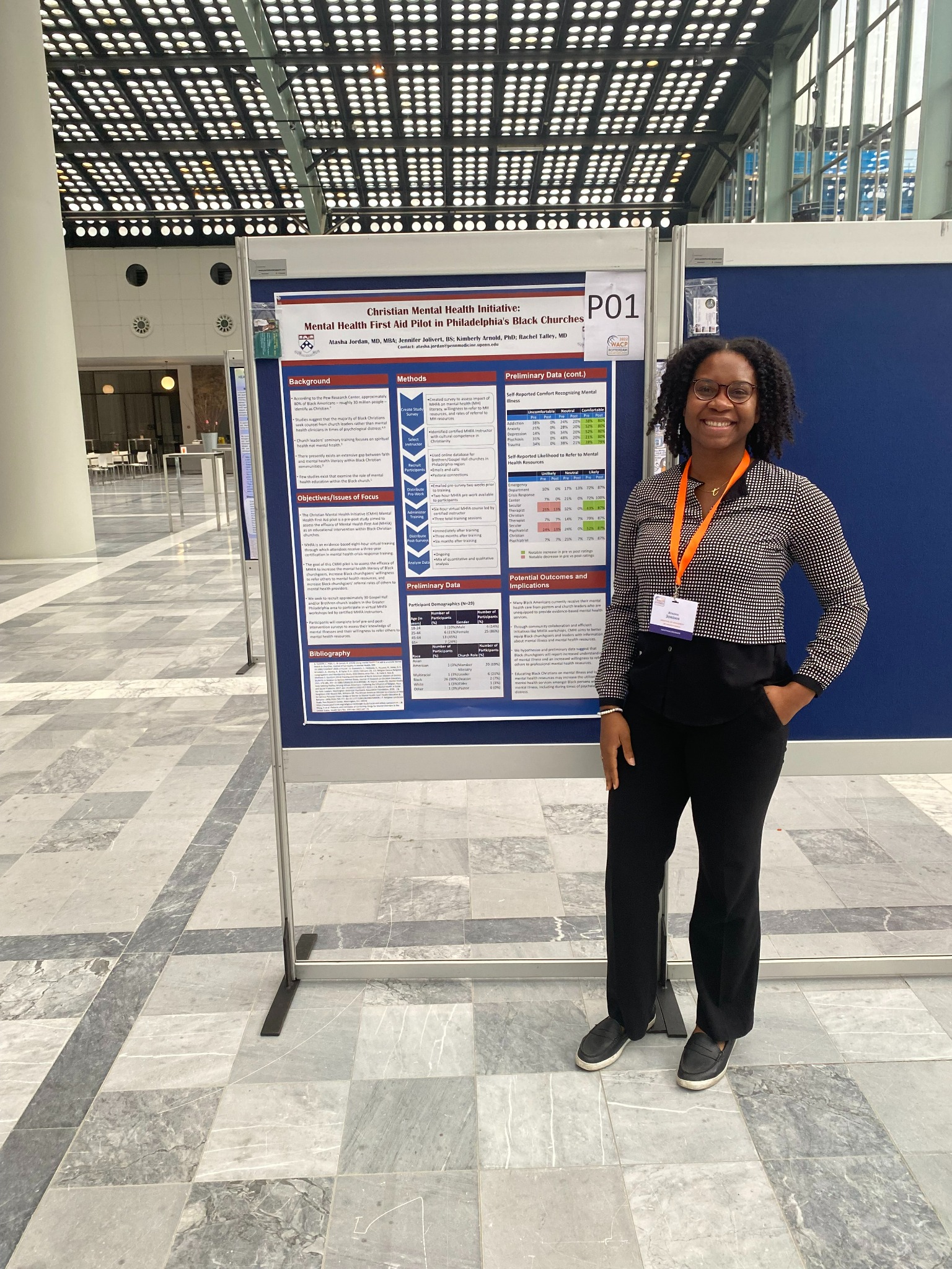 Dr. Atasha Jordan beside her Mental Health First Aid research poster at a Rotterdam conference