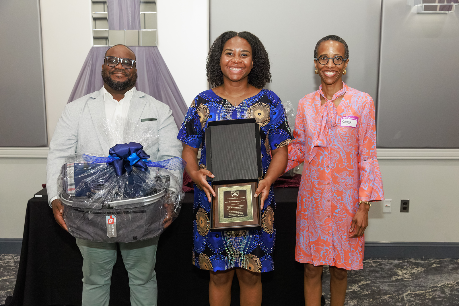 Dr. Atasha Jordan holding a community health award at an event